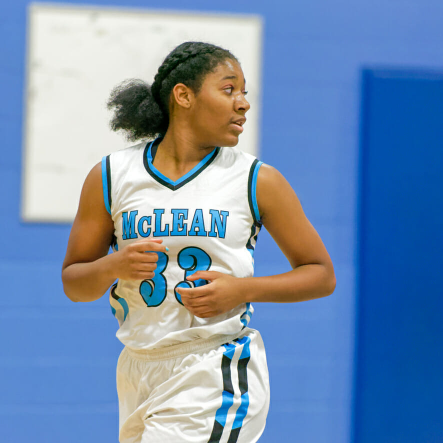 Girls basketball player runs across court