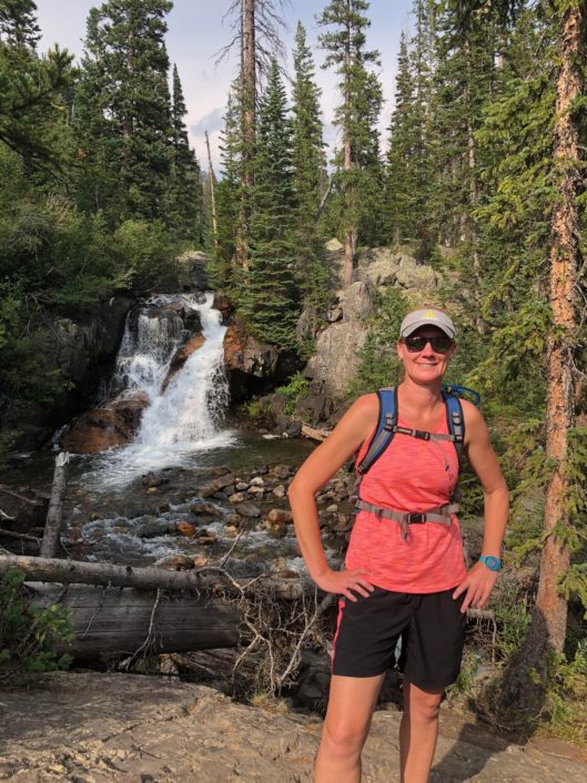 Kerri Sullivan, Second Grade Teacher at McLean School, smiles at camera while hiking