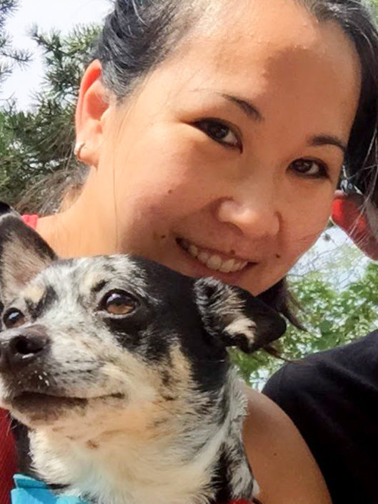 Doris Nhan, Grade 6 teacher at McLean School, smiles at camera with her dog