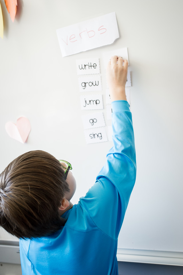 A student working on a whiteboard.